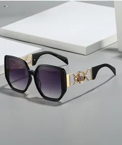 Detail of fashion oversized sunglasses with purple gradient lenses and golden metal temples