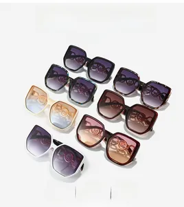 Detail view of large hexagonal sunglasses showing metallic logo and various color options