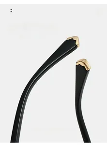 Détail des branches de lunettes noires brillantes avec insert métallique en V doré
