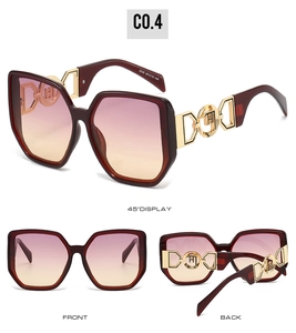 Detail view of burgundy geometric oversized sunglasses with gold hollow metal temples