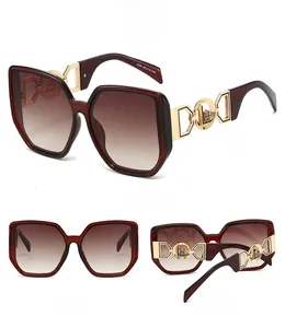 Detail view of burgundy oversized sunglasses with gold geometric hollow temples and gradient lenses