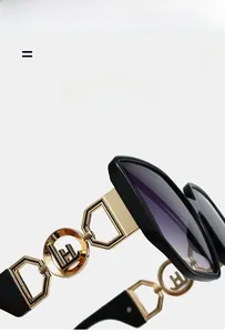 Macro detail of golden hexagonal chain temple design on stylish oversized sunglasses