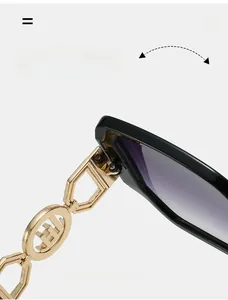 Detail of durable gold metal hinge with hollow decorative symbol on black sunglasses