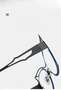 Detail of oversized black cat-eye eyeglass frame featuring hollow side design and silicone pads