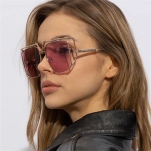 Detailed close-up of luxury metal layered sunglasses with purple gradient lenses