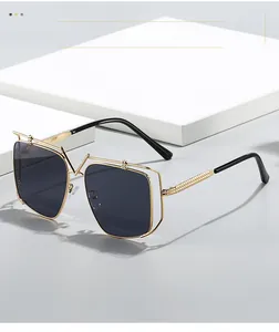 Detail of gold metal double-frame sunglasses with dark gray lenses and V-bridge