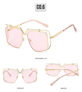 Detail of luxury gold metal square sunglasses with pink lenses and V-shaped bridge design
