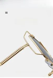 Detail of golden metal sunglasses frame with 3D pyramid texture and flexible temples