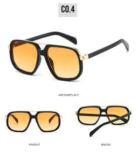 Three perspectives of oversized black PC sunglasses with golden bridge and gradient orange lenses