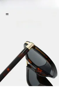 Detail of premium tortoise shell sunglasses featuring durable gold metal hinges and grey lenses