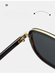 Detail of durable gold metal hinge on oversized tortoiseshell and black sunglasses
