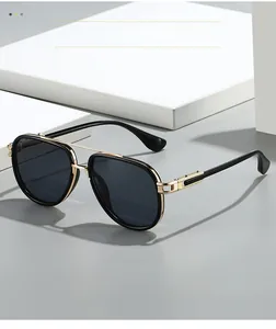 Detail of aviator sunglasses featuring a grey frame and gold metallic temple accents