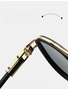 Detail of durable gold-toned metal hinge on classic black sunglasses frame with rivets