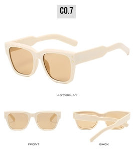 Detail view of square beige sunglasses with vintage rivets and stylish tea lenses