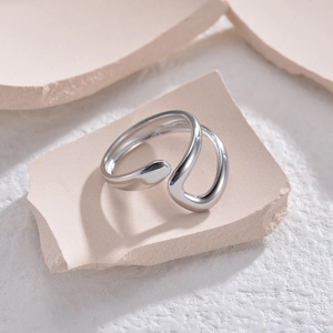 Minimalist polished silver adjustable open ring with sleek fluid lines on stone base