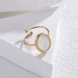 Minimalist gold oval mother of pearl ring with twisted rope texture and open design