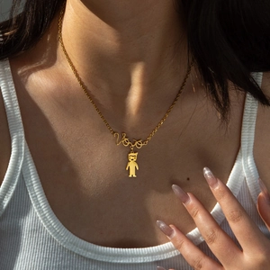 Gold stainless steel necklace with Love pendant and girl charm worn by a model