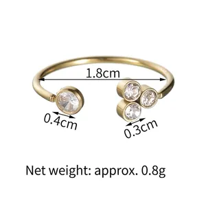 Minimalist gold plated adjustable ring with sparkling cubic zirconia on white background