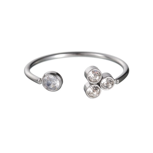 Detailed view of silver stainless steel open bangle with sparkling cubic zirconia clusters