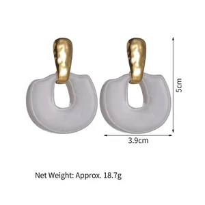 Exaggerated geometric earrings with gold hammered metal and white resin, size 5x3.9cm