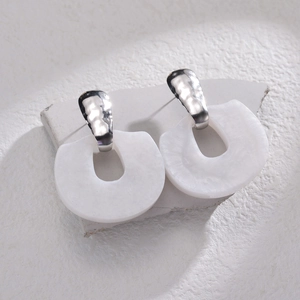 Modern white geometric resin earrings with hammered silver posts on white stone