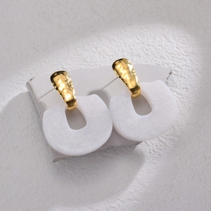 Modern geometric earrings with gold hammered metal and white marble horseshoe pendant