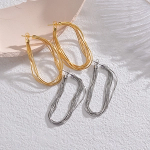 Set of gold and silver multi-layer snake chain earrings in a minimalist woven design
