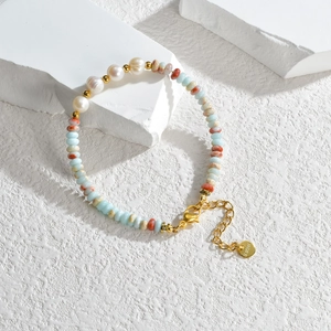 Light blue beaded bracelet with pearls and stainless steel gold accents on stone