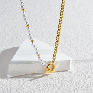 Minimalist pearl and gold chain link necklace with OT toggle clasp on geometric stand