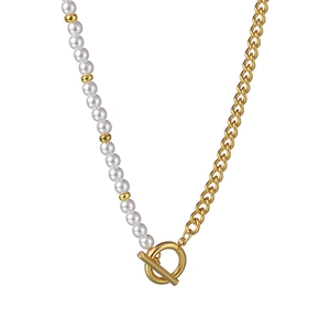 Minimalist asymmetrical pearl and gold chain necklace with toggle OT clasp on white background