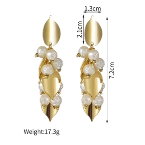 Macro detail of gold tassel earrings with leaf charms and rose pearls, 7.2cm length