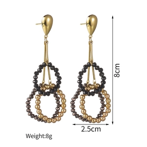 Detailed view of gold tassel earrings with beaded rings measuring 8cm in length