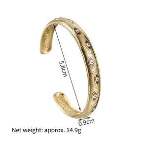 Gold evil eye open bangle in stainless steel with colorful enamel eye details