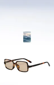 Detailed close-up of tortoise square frame sunglasses with metal rivets and tinted lenses