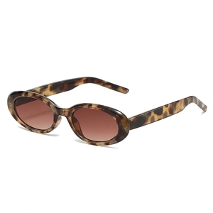 Vintage oval tortoise shell sunglasses with brown lenses shown from a side angle view