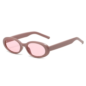 Retro oval sunglasses with matte pink frames and translucent lenses in a studio setting