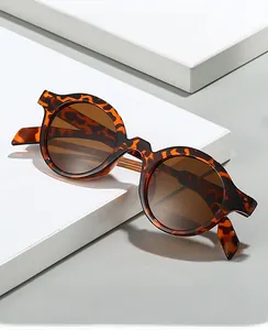 Detail view of tortoiseshell round frames with light brown lenses and premium hinges