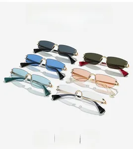 Close-up of rimless rectangular sunglasses featuring signature gold metal C-hinge details