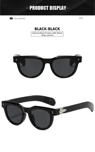 Detail view of square black sunglasses with silver hinge metal decor and grey lenses