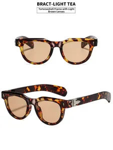 Detail showing tortoise frame sunglasses with light tea lenses and metal hinges