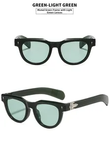 Detail of green square sunglasses featuring silver cross metal rivets on the temples