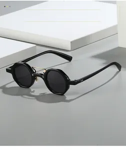 Detail of vintage black round sunglasses featuring golden metal double bridge and rivets