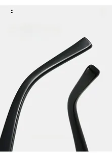 Detail view of ergonomic curved temple design on sleek black fashion sunglasses