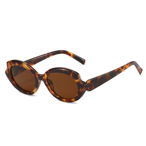 Retro thick-frame tortoise shell sunglasses with futuristic wavy edges and brown lenses