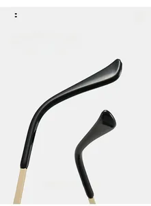 Detail of curved golden metal temples with black tips for enhanced wearing comfort