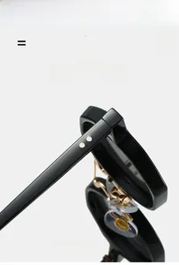 Detail showing silver rivets on black frame and adjustable gold-tone nose pads