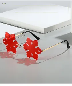 Macro shot of red snowflake-shaped lenses with gold metal temples and shadow detail