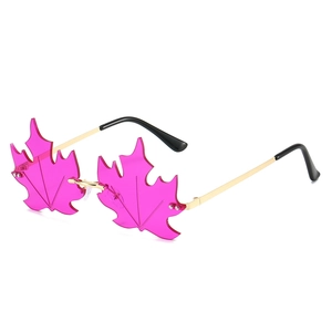 Frameless maple leaf shaped sunglasses with pink lenses and gold metal temples