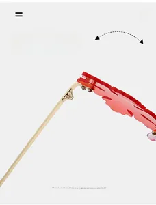 Detail of durable gold metal hinge and red flame-shaped frame on stylish sunglasses
