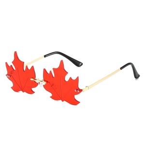 Unique rimless maple leaf shaped sunglasses with red transparent lenses and gold metal frame